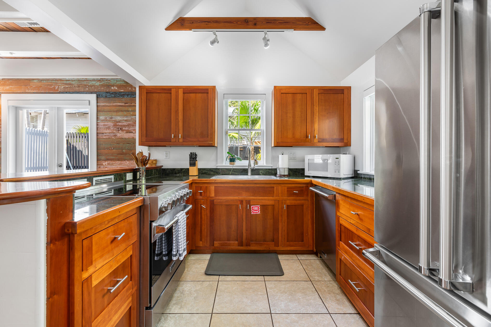 819 Elizabeth Street Key West, FL 33040 - Photo 12 of 28 a kitchen with stainless steel appliances granite countertop a stove a sink dishwasher and a refrigerator