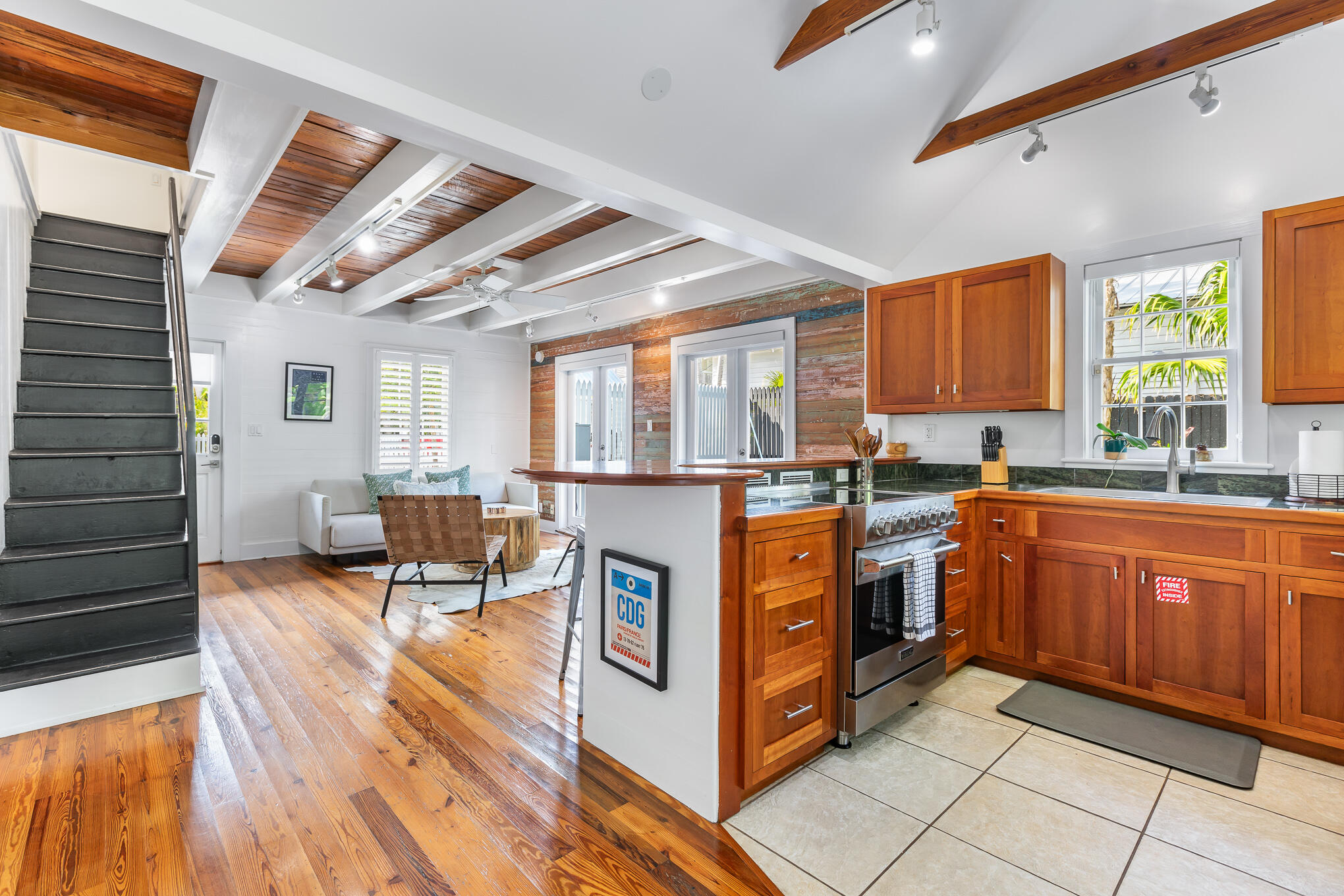 819 Elizabeth Street Key West, FL 33040 - Photo 8 of 28 a kitchen with stainless steel appliances granite countertop wooden cabinets a sink and a stove