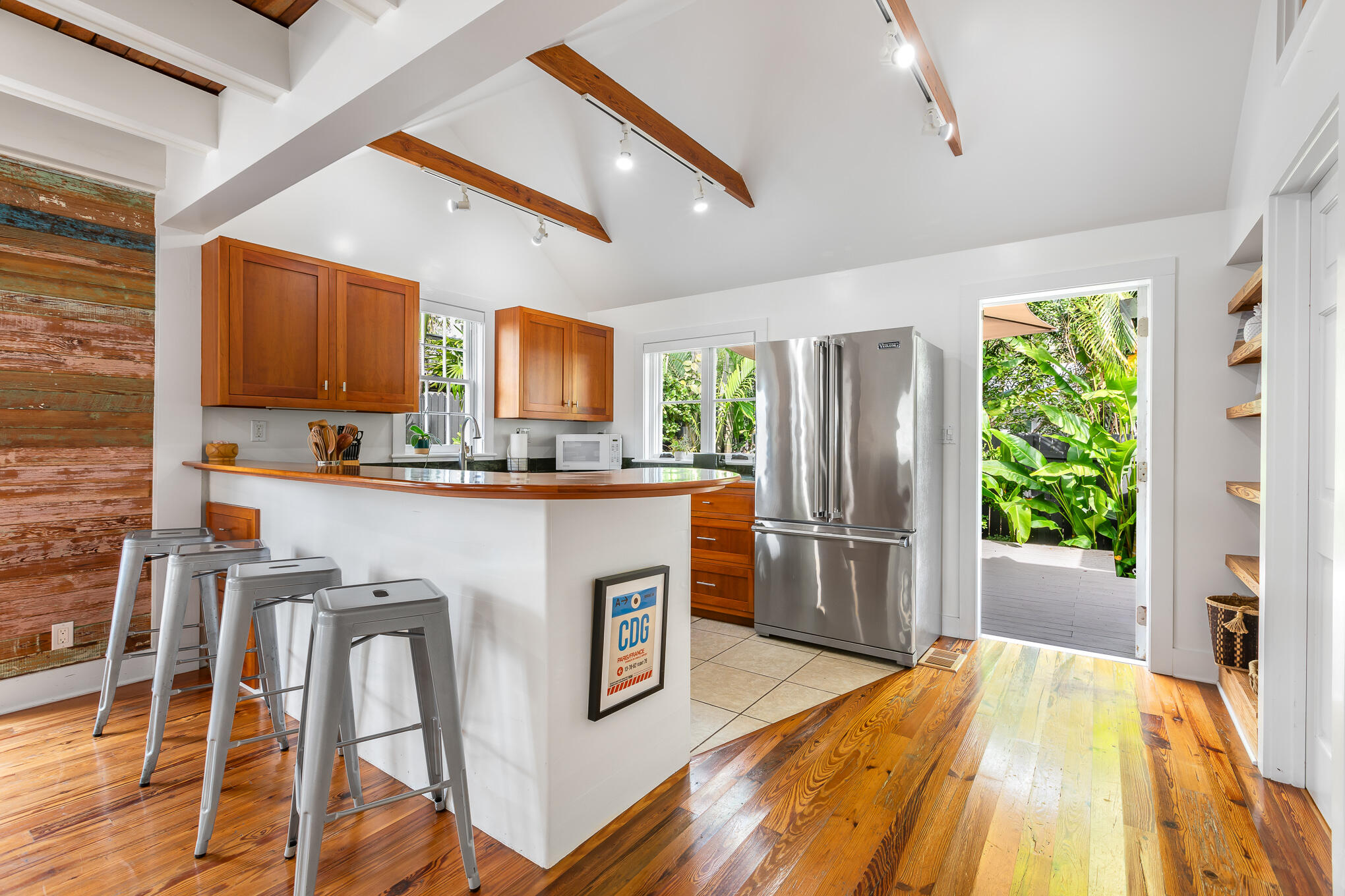 819 Elizabeth Street Key West, FL 33040 - Photo 10 of 28 a kitchen with stainless steel appliances granite countertop a refrigerator a stove a sink and dishwasher with wooden floor