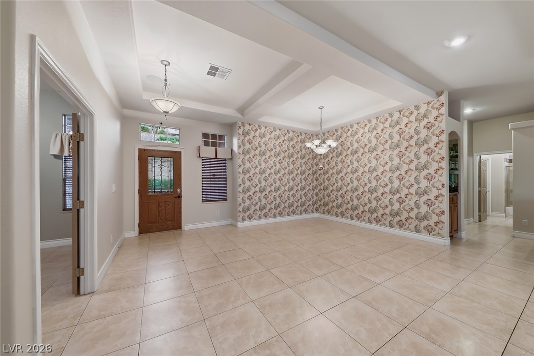 1104 Norellat Road Henderson, NV 89011 - Photo 9 of 52 Tiled flooring and tray ceilings define this welcoming entry and dining space.