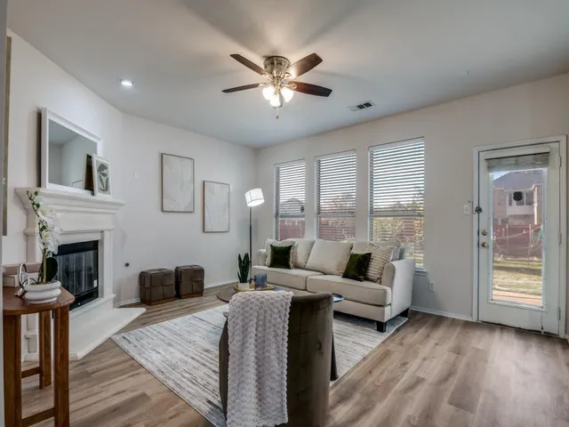 a living room with furniture and a fireplace