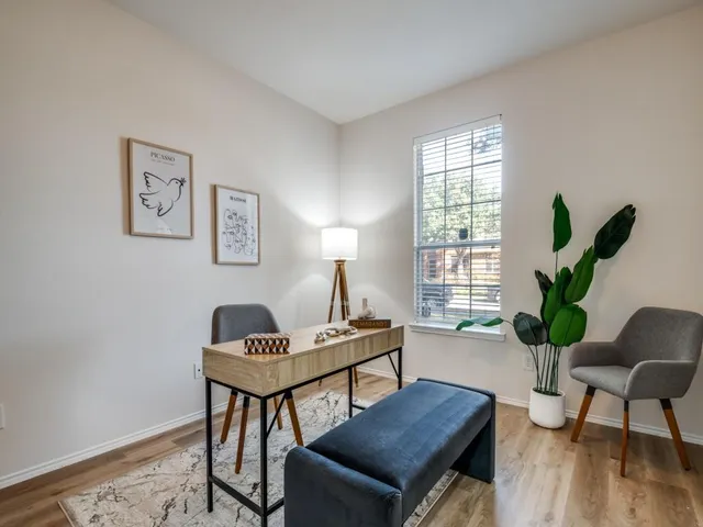 a work room with furniture and a potted plant
