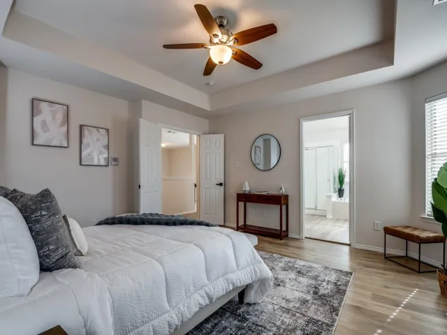 a bedroom with a bed mirror and a window
