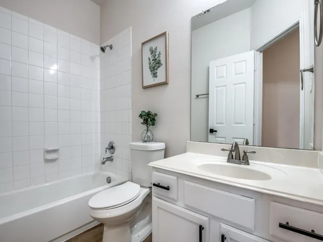 a bathroom with a sink toilet a mirror and shower