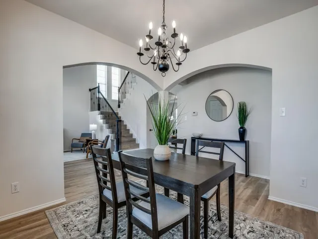 a view of a dining room with furniture and chandelier
