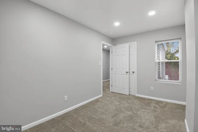 a bathroom with a toilet a sink a vanity and mirror