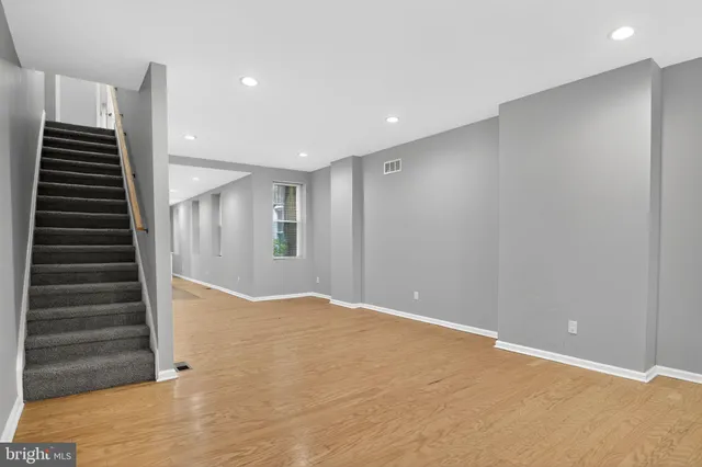 an empty room with wooden floor