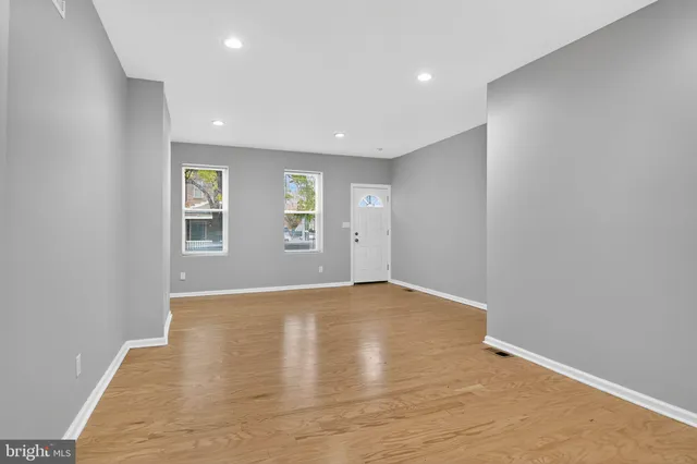 an empty room with windows and closet