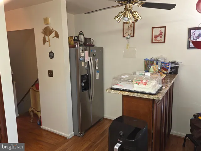 a kitchen with stainless steel appliances granite countertop a refrigerator and a stove