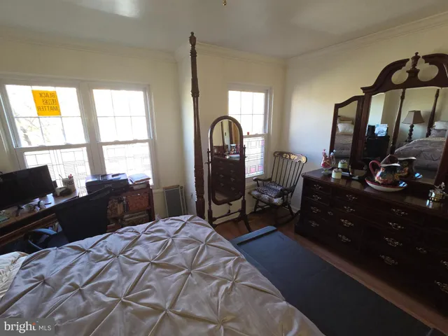 a bedroom with a bed dresser and a window