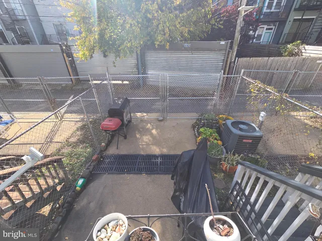 a view of a chairs and tables in the back yard of the house