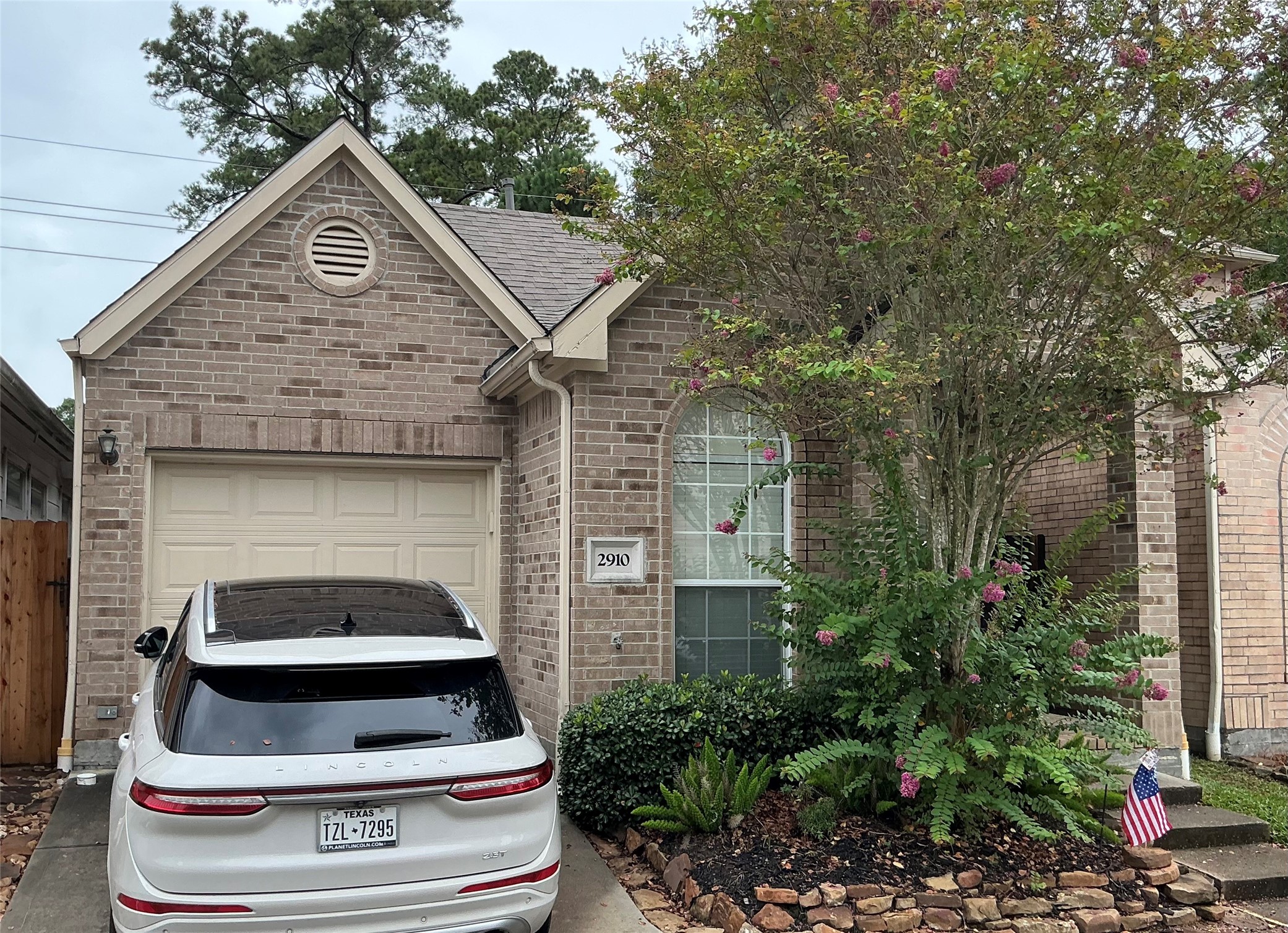 2910 Crescent Bend Road Spring, TX 77388 - Photo 2 of 29 This cozy brick home features a single-car garage and a charming front garden with mature trees and shrubs. The entrance is inviting, with a well-maintained driveway and a welcoming atmosphere.