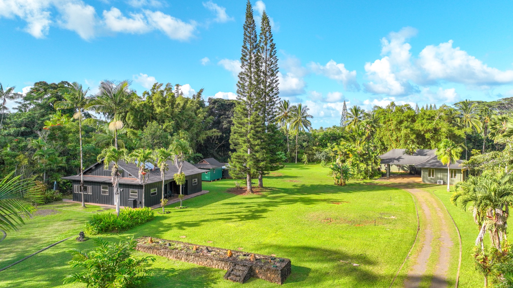4631 Kahiliholo Road Kilauea, HI 96754 - Photo 5 of 11 a view of an house with backyard space and garden