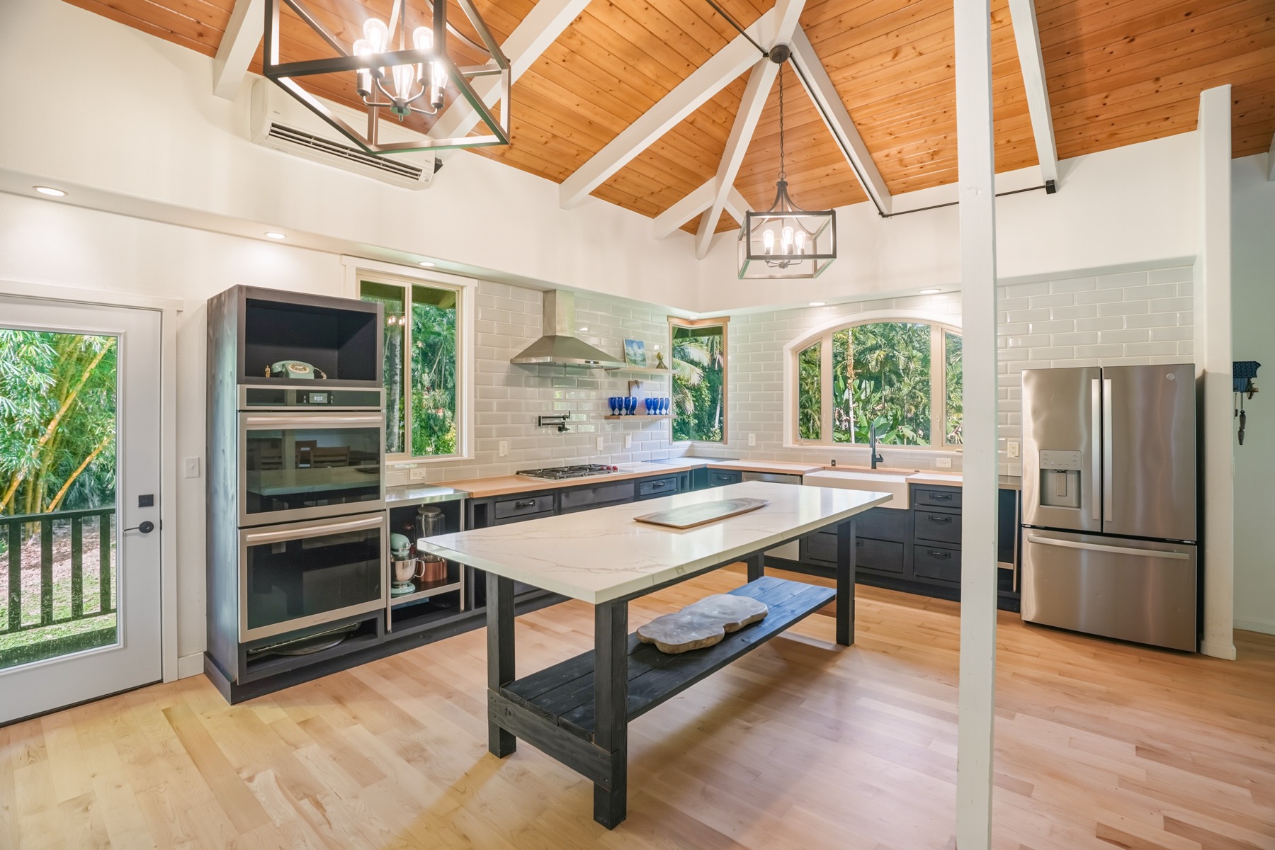 4631 Kahiliholo Road Kilauea, HI 96754 - Photo 7 of 11 a room with stainless steel appliances wooden floor and windows