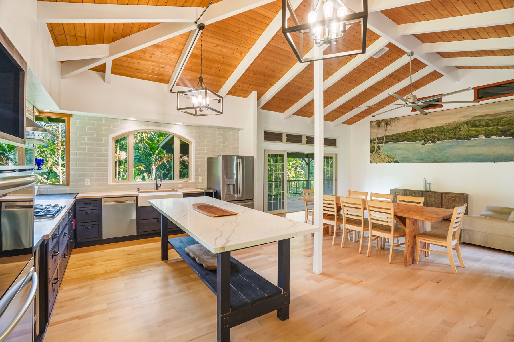 4631 Kahiliholo Road Kilauea, HI 96754 - Photo 8 of 11 a kitchen with a table chairs stove and refrigerator