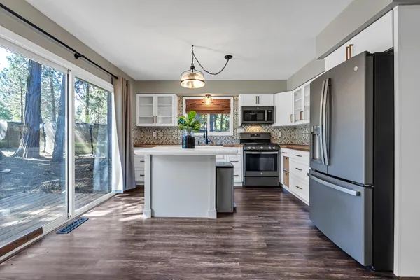 a kitchen with granite countertop a refrigerator and a stove