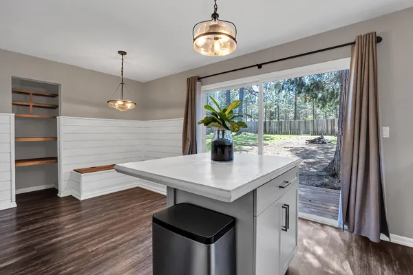 a view of a kitchen area with furniture and wooden floor