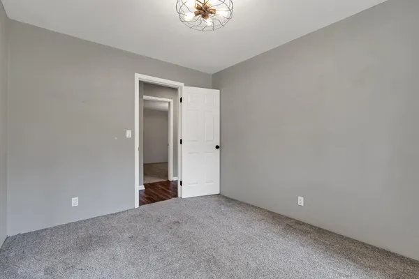 a view of an empty room with a closet