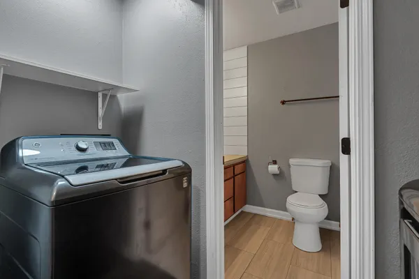 a view of washer and dryer with wooden floor