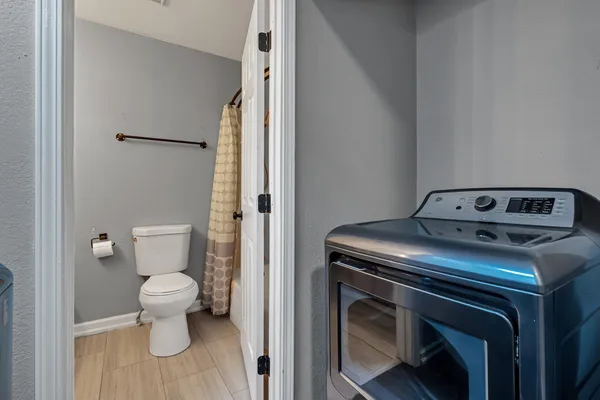 a bathroom with a sink a toilet and mirror