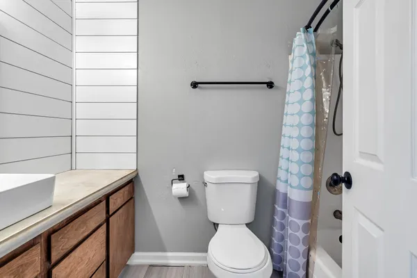 a view of backyard with wooden fence and large trees