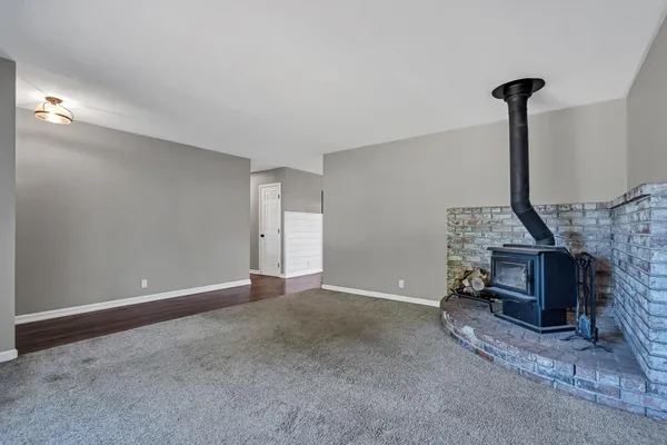 a view of an empty room with a fireplace