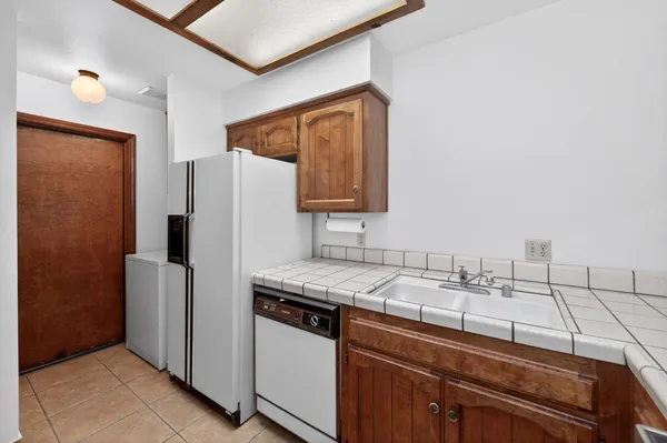 wooden floor in an empty room with a kitchen