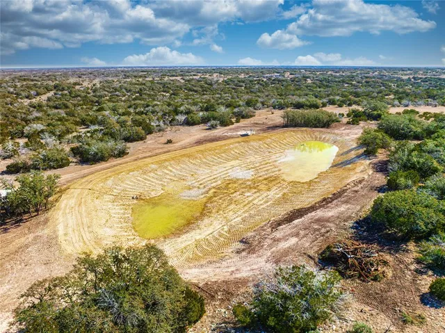 a kitchen with stainless steel appliances granite countertop a dining table chairs sink and cabinets