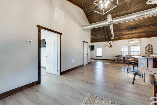 a kitchen with cabinets and wooden floor