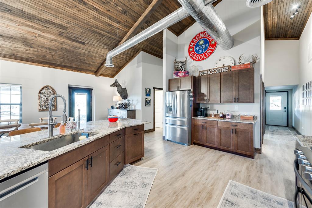 2527 Sutton County Road Ozona, TX 76943 - Photo 18 of 39 a kitchen with cabinets and wooden floor