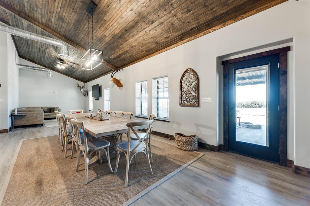 2527 Sutton County Road Ozona, TX 76943 - Photo 19 of 39 a view of a dining room with furniture window and wooden floor
