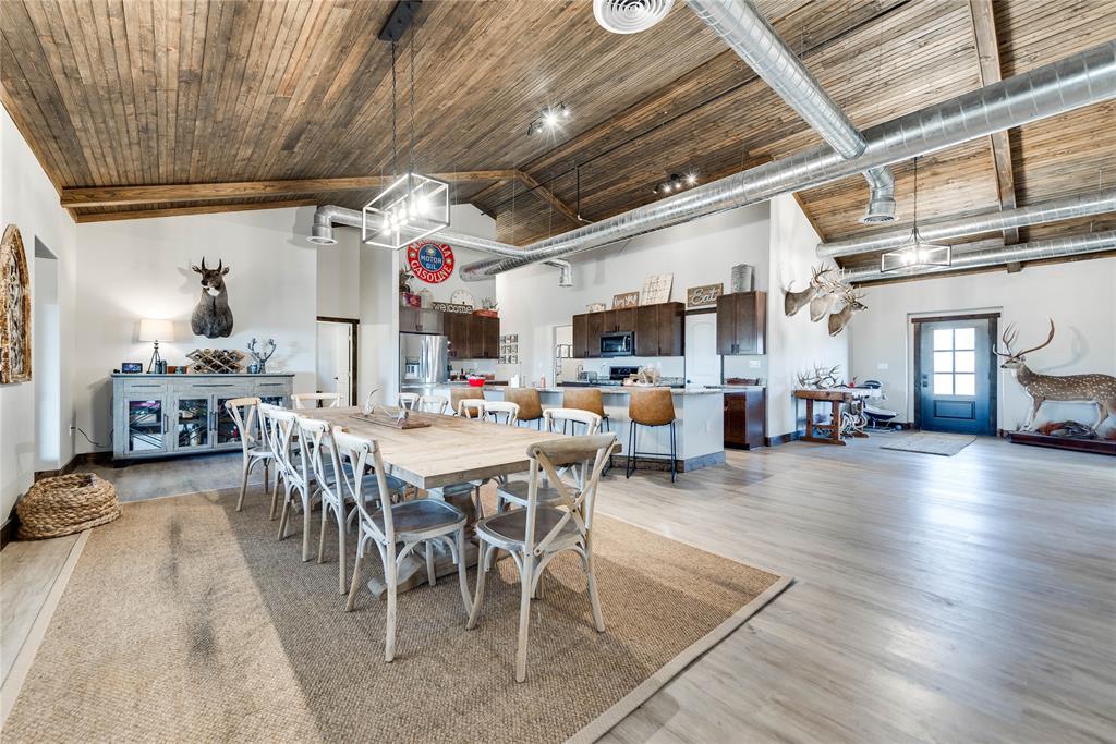 2527 Sutton County Road Ozona, TX 76943 - Photo 21 of 39 a view of a dining room with furniture wooden floor and a chandelier