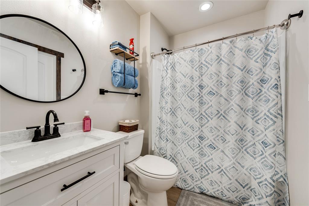 2527 Sutton County Road Ozona, TX 76943 - Photo 25 of 39 a bathroom with a sink a mirror a toilet and a sink