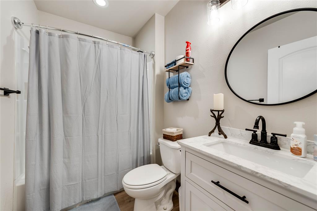 2527 Sutton County Road Ozona, TX 76943 - Photo 34 of 39 a bathroom with a sink a toilet and a mirror