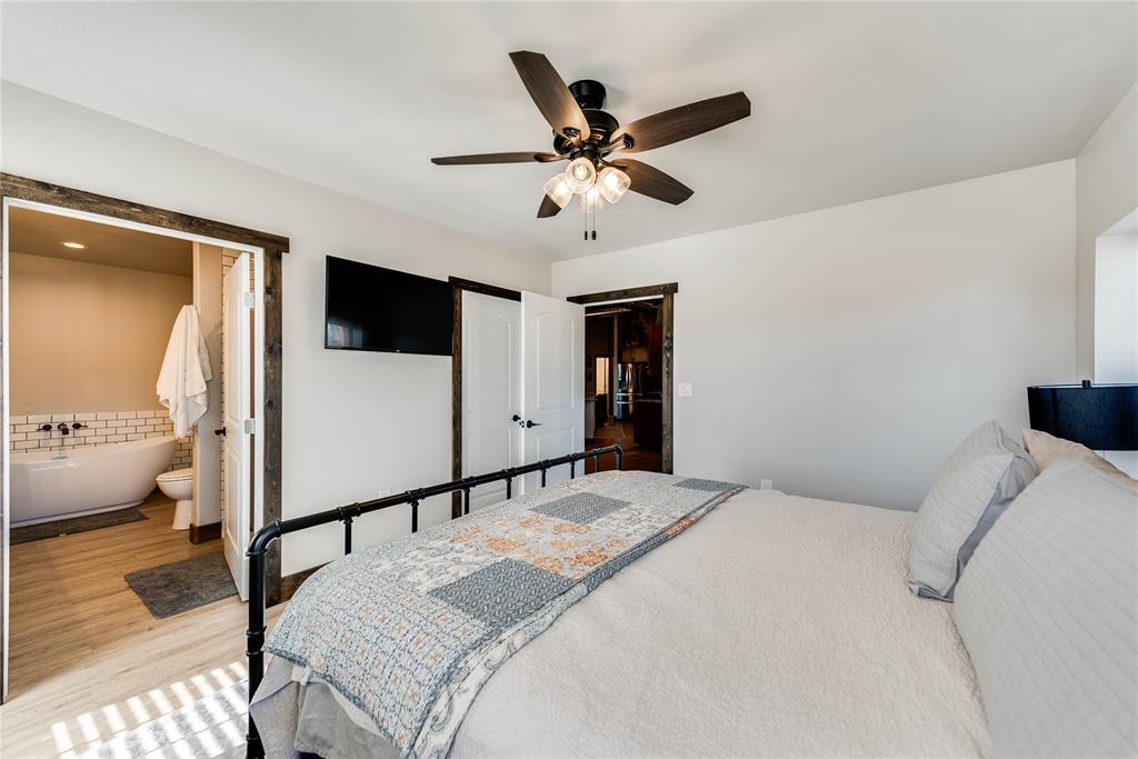 2527 Sutton County Road Ozona, TX 76943 - Photo 36 of 39 a bedroom with a bed and a large mirror