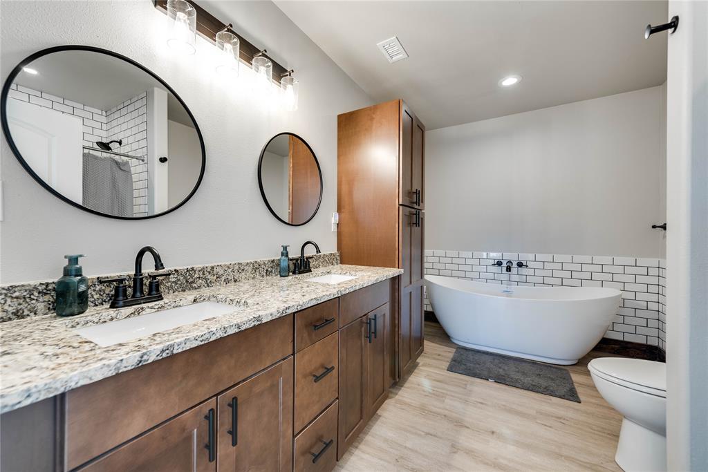 2527 Sutton County Road Ozona, TX 76943 - Photo 37 of 39 a bathroom with a toilet a sink and a mirror