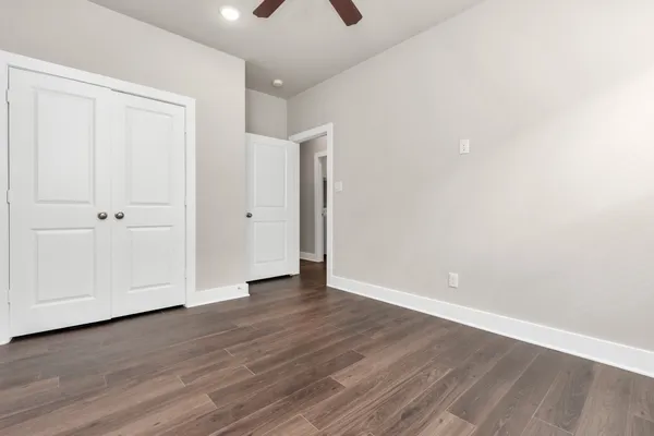a view of an empty room with wooden floor