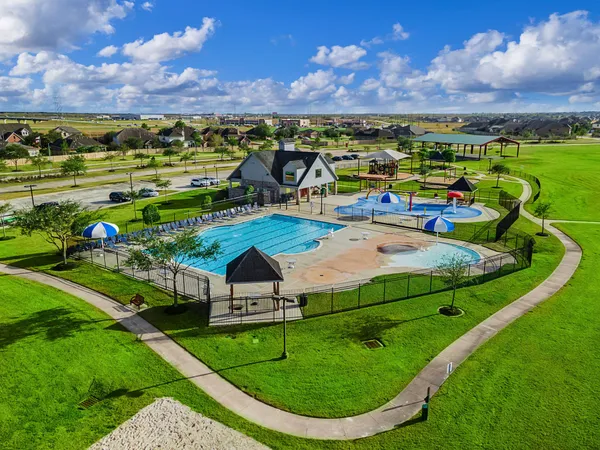 a view of a swimming pool with a yard