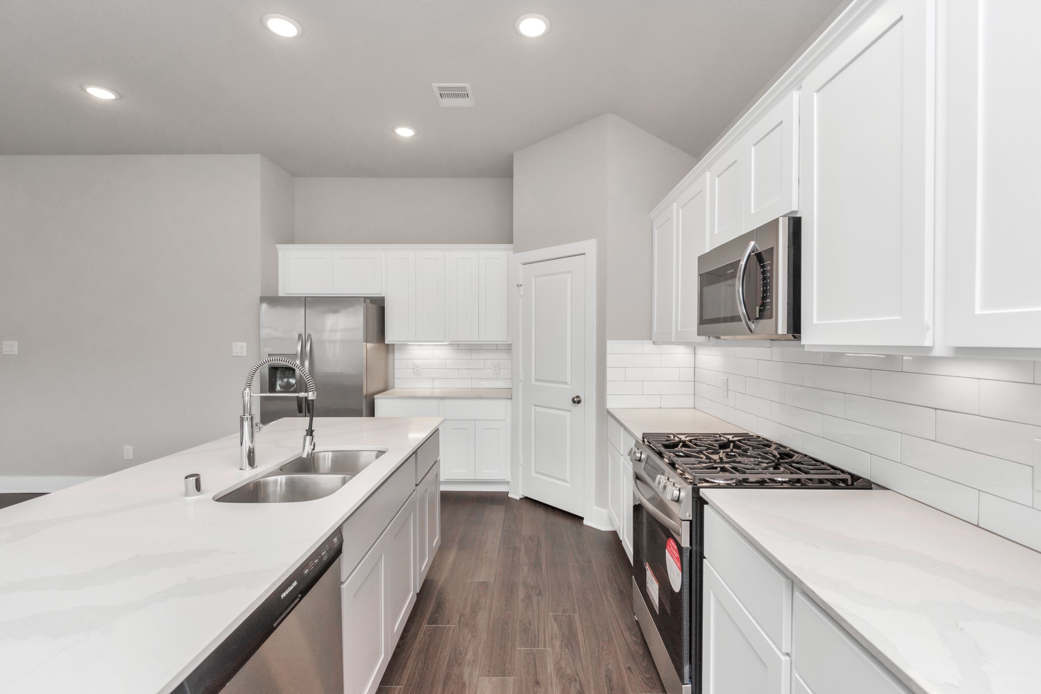 10622 Cascade Crk Drive Rosharon, TX 77583 - Photo 5 of 24 Another view from the kitchen shows the extensive storage including a pantry next to the refrigerator.