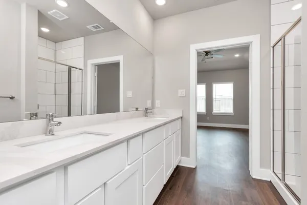a bathroom with a double vanity sink and a mirror