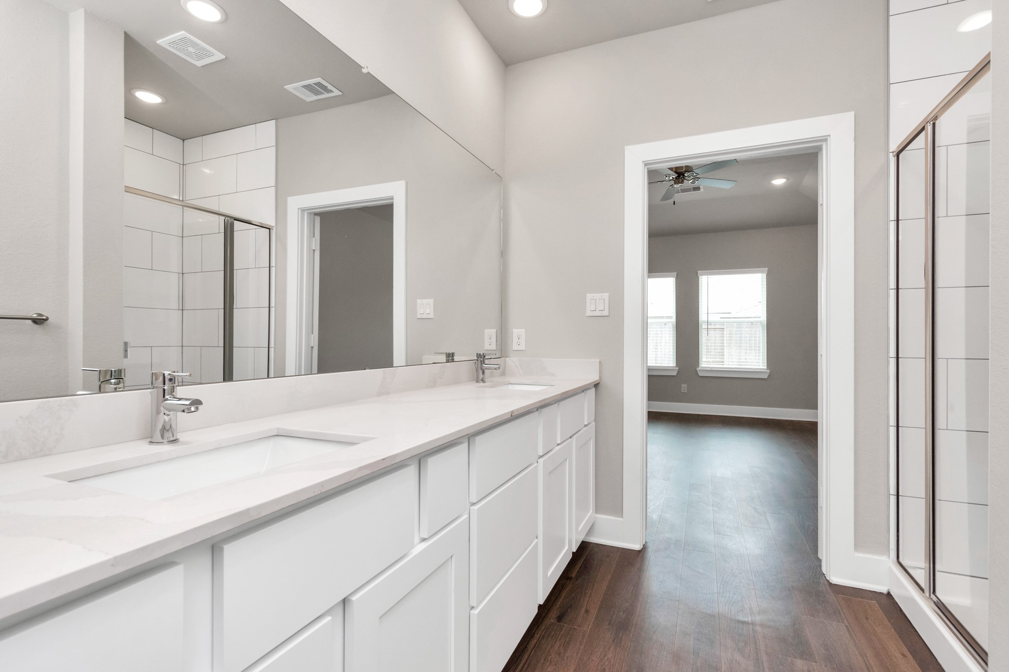 10622 Cascade Crk Drive Rosharon, TX 77583 - Photo 9 of 24 Quartz countertops, double sinks, and ceramic tile shower, and private lavatory closet highlight the luxurious primary bath.