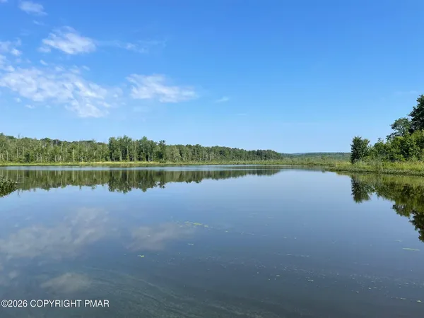 a view of lake with houses in the background
