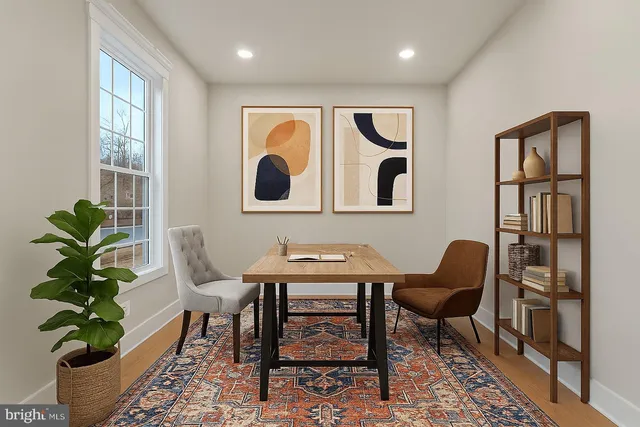 a view of a workspace with furniture and a potted plant