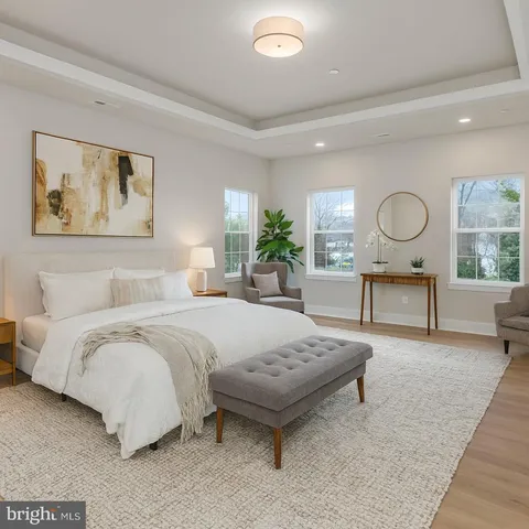 a bedroom with a bed a table and painting on the wall