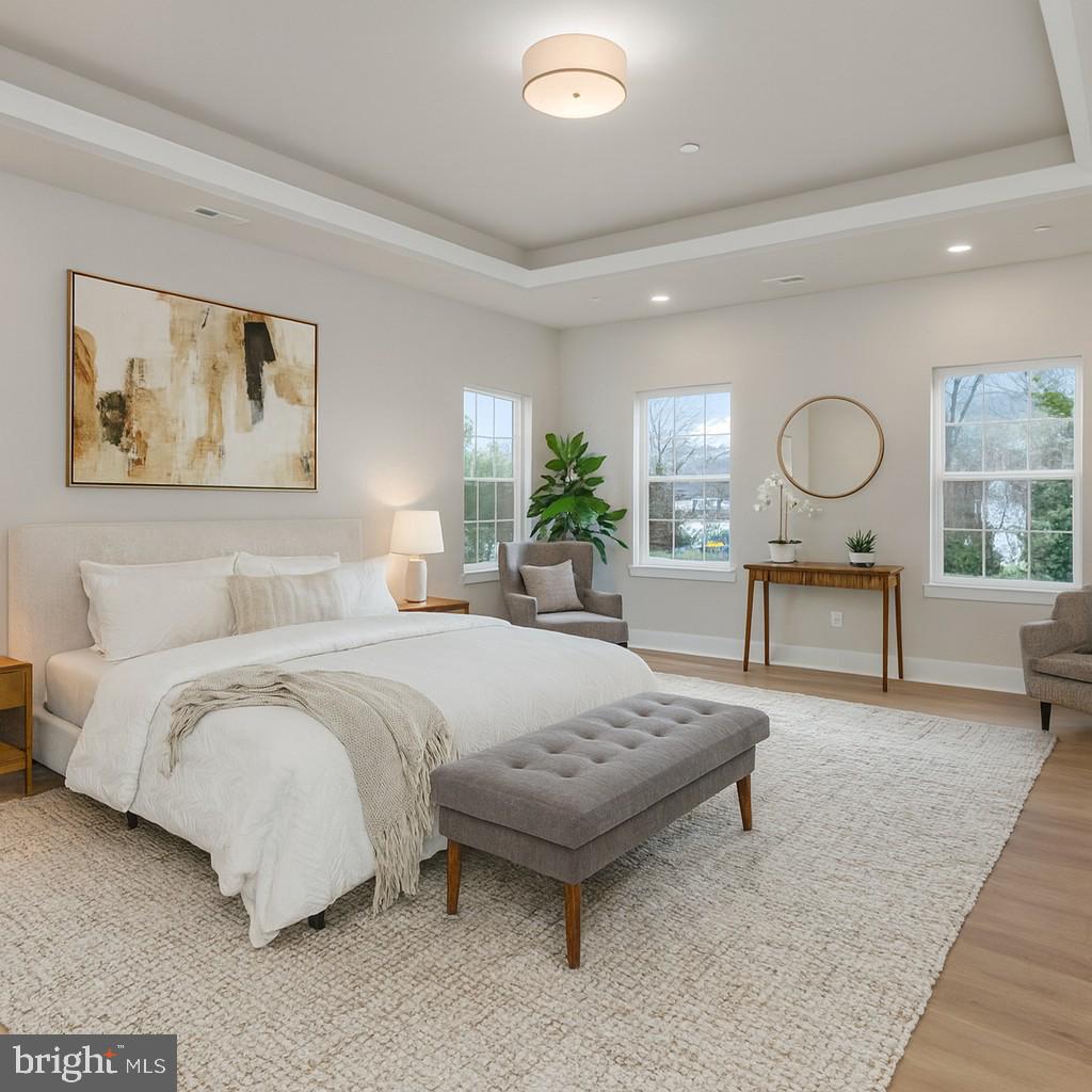 17 Vinter Lane Pasadena, MD 21122 - Photo 22 of 40 a bedroom with a bed a table and painting on the wall