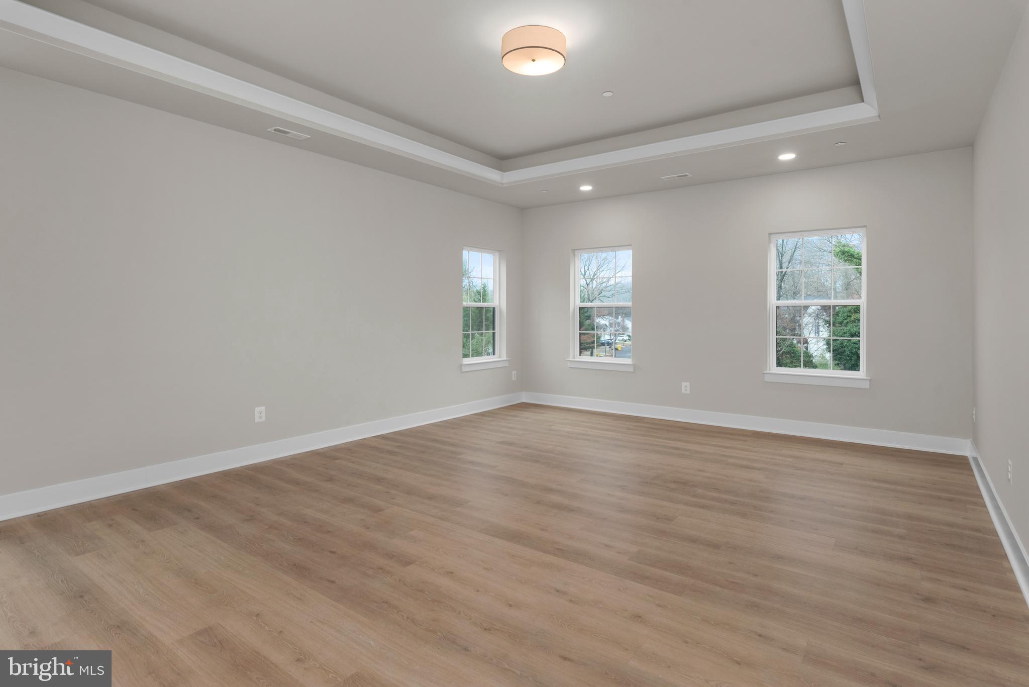 17 Vinter Lane Pasadena, MD 21122 - Photo 23 of 40 an empty room with wooden floor and windows