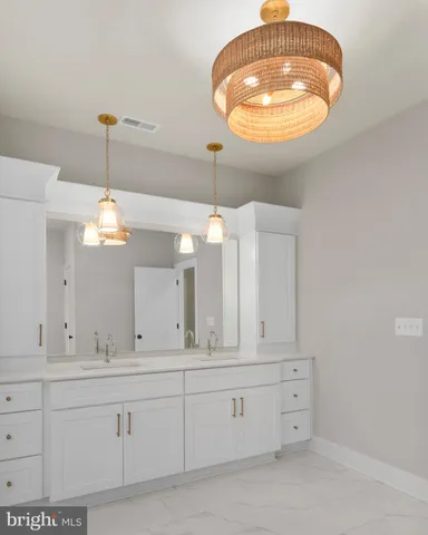 a bathroom with a sink vanity and mirror