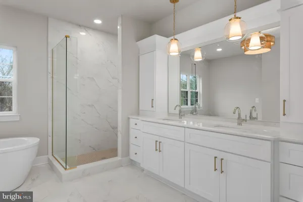 a bathroom with a double vanity sink mirror and toilet