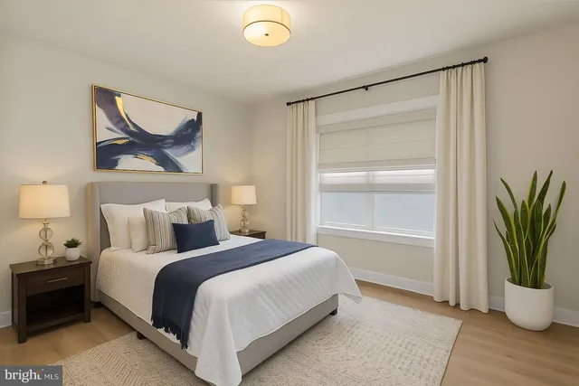 a bedroom with a bed and a painting on the wall