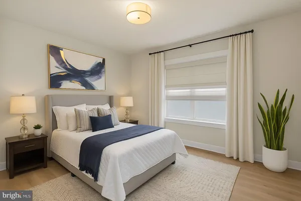 a bedroom with a bed and a painting on the wall